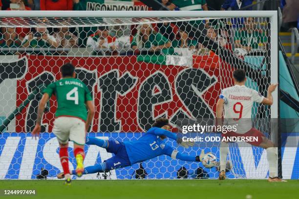 Mexico's goalkeeper Guillermo Ochoa saves a penalty shot by Poland's forward Robert Lewandowski during the Qatar 2022 World Cup Group C football...