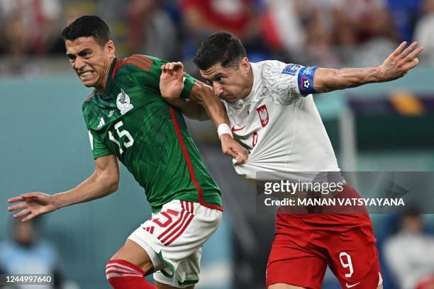 Poland's forward Robert Lewandowski is fouled by Mexico's defender Hector Moreno and is awarded a penalty during the Qatar 2022 World Cup Group C...