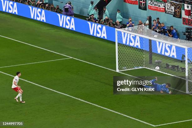 Mexico's goalkeeper Guillermo Ochoa stops a penalty kick taken by Poland's forward Robert Lewandowski during the Qatar 2022 World Cup Group C...