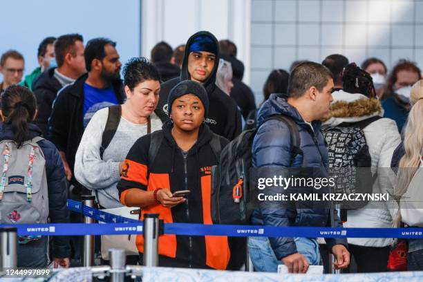 Travelers stand in a security line at O'Hare International Airport in Chicago, Illinois, on November 22 ahead of the upcoming Thanksgiving holiday. -...