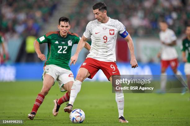 Hirving Lozano of Mexico battles for the ball with Robert Lewandowski of Poland during the Group C - FIFA World Cup Qatar 2022 match between Mexico...