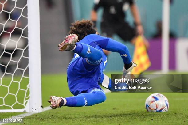 Guillermo Ochoa of Mexico stops the penalty of Robert Lewandowski of Poland during the Group C - FIFA World Cup Qatar 2022 match between Mexico and...