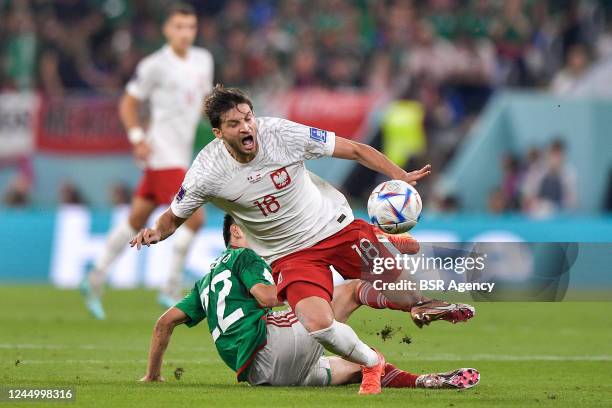 Hirving Lozano of Mexico battles for the ball with Bartosz Bereszynski of Poland during the Group C - FIFA World Cup Qatar 2022 match between Mexico...