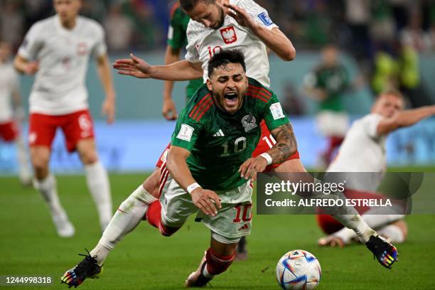 Poland's midfielder Grzegorz Krychowiak fights for the ball with Mexico's forward Alexis Vega during the Qatar 2022 World Cup Group C football match...