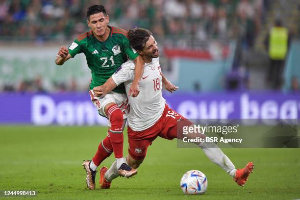 Uriel Antuna of Mexico battles for the ball with Bartosz Bereszynski of Poland during the Group C - FIFA World Cup Qatar 2022 match between Mexico...
