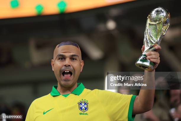 Fan dressed as Ronaldo of Brazil poses with a replica trophy during the FIFA World Cup Qatar 2022 Group D match between France and Australia at Al...