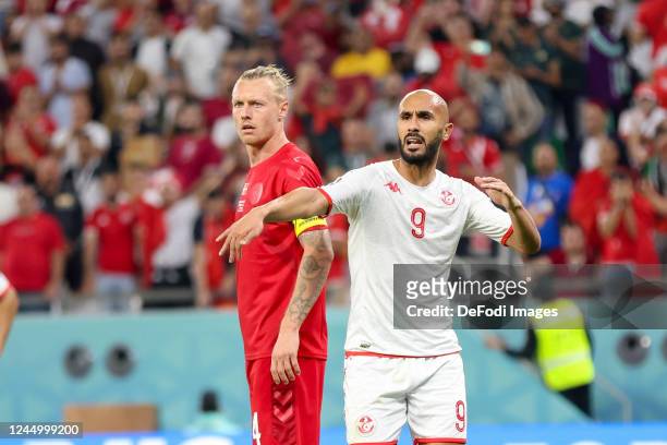 Simon Kjaer of Denmark and Issam Jebali of Tunisia gesture during the FIFA World Cup Qatar 2022 Group D match between Denmark and Tunisia at...