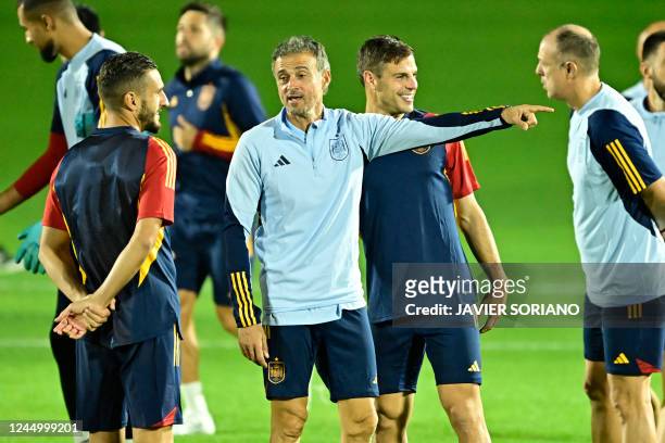 Spain's midfielder Koke, Spain's coach Luis Enrique and Spain's defender Cesar Azpilicueta attend a training session at the Qatar University Training...