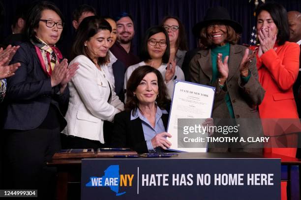 Attendees applaud after New York State Governor Kathy Hochul announced actions to combat hate crimes, at her office in New York City on November 22,...