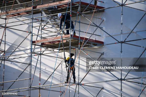 Workers service a yacht at La Ciotat shipyards, south-eastern France on November 22, 2022. - The shipyard of La Ciotat was closed down in 1987, but...