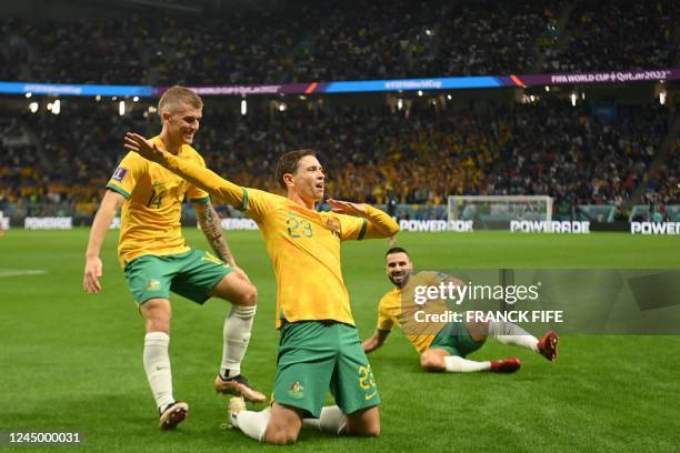 Australia's midfielder Craig Goodwin celebrates with teammates after he scored the opening goal during the Qatar 2022 World Cup Group D football...