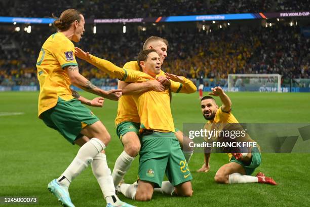 Australia's midfielder Craig Goodwin celebrates with teammates after he scored the opening goal during the Qatar 2022 World Cup Group D football...