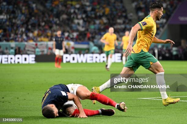 France's defender Lucas Hernandez reacts after he sustained an injury during the Qatar 2022 World Cup Group D football match between France and...