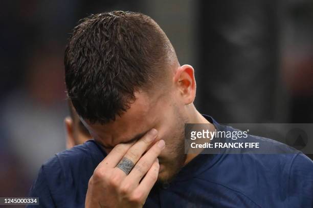 France's defender Lucas Hernandez reacts as he leaves the pitch after he sustained an injury during the Qatar 2022 World Cup Group D football match...