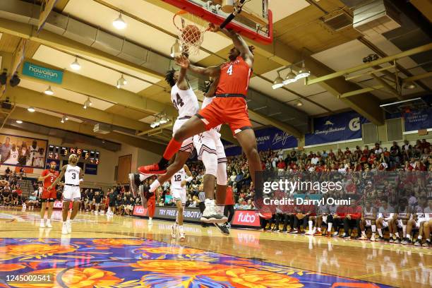 Robert Jennings of the Texas Tech Red Raiders dunks over Jae'Lyn Withers and Kamari Lands of the Louisville Cardinals in the first half of the game...