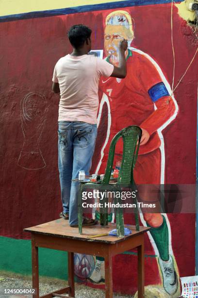 An artist paints Portugal football player Cristiano Ronaldo to celebrate Qatar World Cup 2022 at Gopalnagar on November 22, 2022 in Kolkata, India.