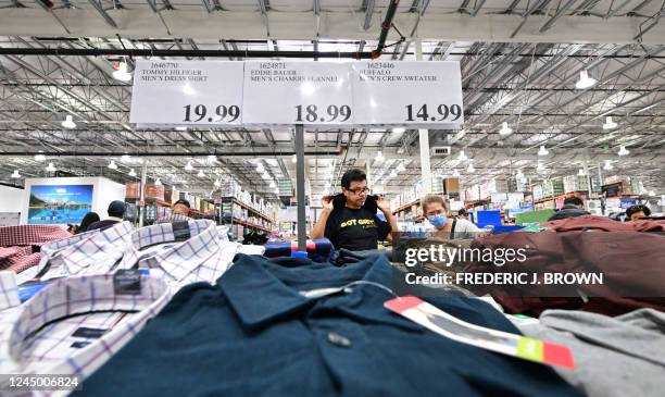 People shop for clothing at a Costco store in Monterey Park, California on November 22, 2022. Analysts cited good results from Best Buy and some...