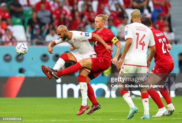 Issam Jebali 1st L of Tunisia vies with Simon Kjaer 2nd L of Denmark during the Group D match between Denmark and Tunisia at the 2022 FIFA World Cup...