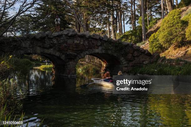 Couple enjoys in a rowing boat at the Stow Lake of Golden Gate Park in San Francisco, California, United States on November 22, 2022.