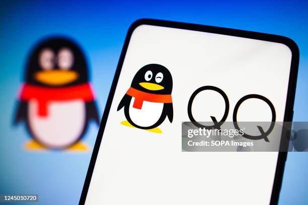 In this photo illustration, the Tencent QQ logo is displayed on a smartphone screen and in the background.