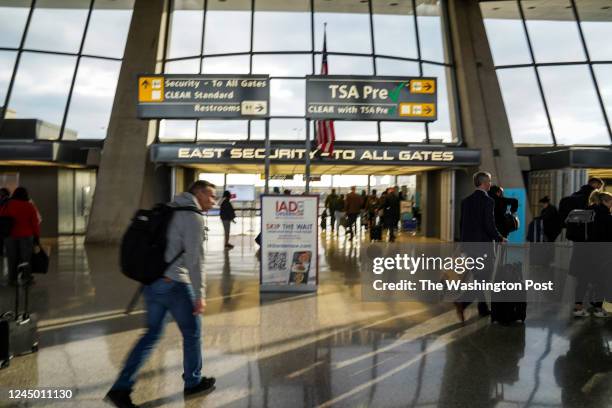 Passengers head toward the gates at Dulles International Airport on November 17 in Dulles, VA. The airport is celebrating its 60th anniversary after...