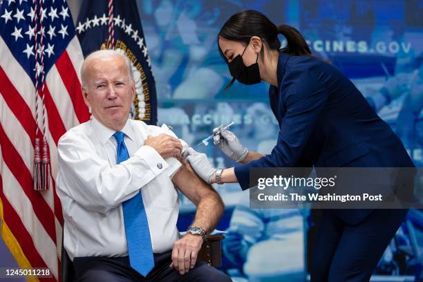 President Joe Biden receives a COVID-19 Vaccine booster shot inside the South Court Auditorium at the White House in Washington on Tuesday, October...