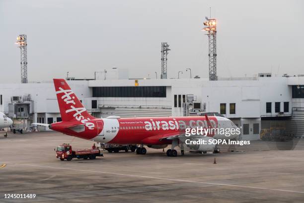 Thai AirAsia Airbus A320-200 commercial passenger plane is seen parked at the international departures terminal at Don Mueang International Airport...