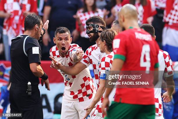 Croatia's defender Dejan Lovren argues with Argentinian referee Fernando Rapallini during the Qatar 2022 World Cup Group F football match between...