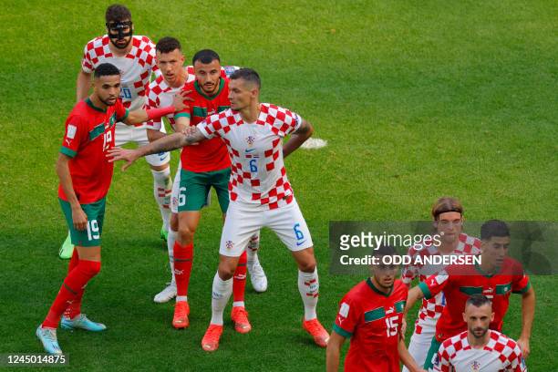 Croatia's defender Dejan Lovren gestures towards Morocco's forward Youssef En-Nesyri during a free kick during the Qatar 2022 World Cup Group F...