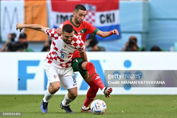 Croatia's midfielder Mateo Kovacic and Morocco's midfielder Hakim Ziyech fight for the ball during the Qatar 2022 World Cup Group F football match...