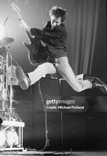 Pete Townshend of The Who leaps in the air while performing live on stage, London, February 1981.