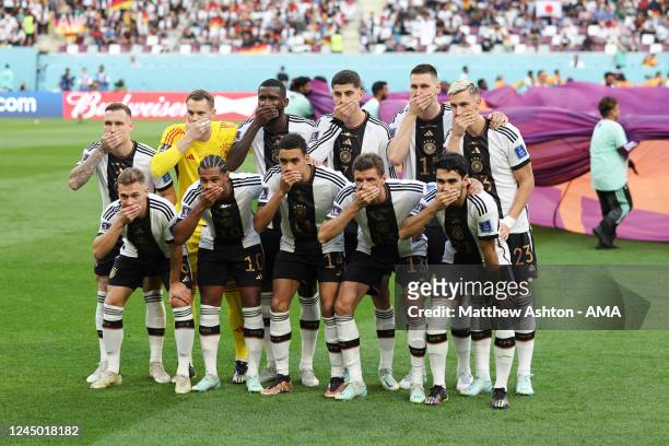 The players of Germany pose with their hands covering their mouths in the team group picture before the FIFA World Cup Qatar 2022 Group E match...