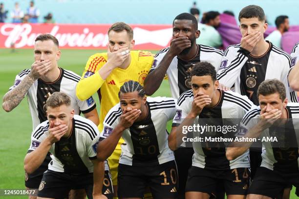 The players of Germany pose with their hands covering their mouths in the team group picture before the FIFA World Cup Qatar 2022 Group E match...