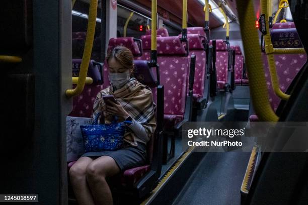 Women riding on a bus operated by Kowloon Motor Bus Company Limited on November 23, 2022 in Hong Kong, China.