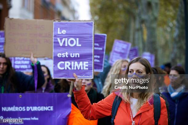 Woman holds a placard reading 'Rape is a crime'. Women from the collective NousToutes organized a nationwide march in France against feminicides,...