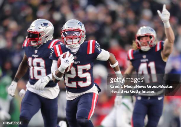 New England Patriots cornerback Marcus Jones runs back a punt return for a touchdown during the final seconds of the fourth quarter of the game...