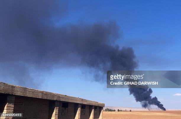 This picture shows smoke plumes rising in a field following reported Turkish drone strikes near the town of al-Qahtaniyah in Syria's northeastern...
