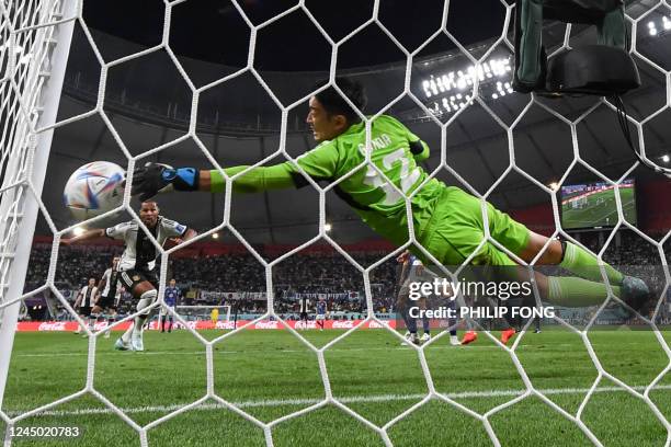 Japan's goalkeeper Shuichi Gonda makes a save during the Qatar 2022 World Cup Group E football match between Germany and Japan at the Khalifa...