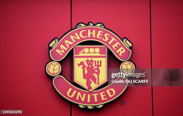 Manchester United logo is pictured outside of Old Trafford stadium, home ground of Manchester United football team, in Manchester, northern England,...