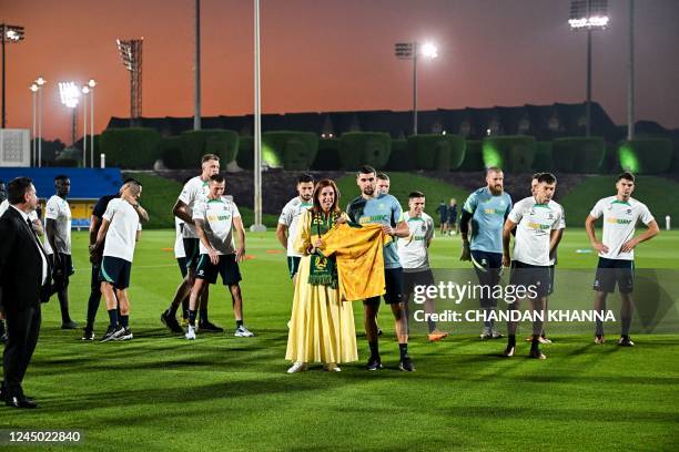 Australian Minister for Sport Anika Wells gets a signed jersey from Australia's goalkeeper Mathew Ryan before their training session at the Aspire...