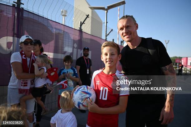 Denmark's defender Simon Kjaer poses for a picture with a young fan at Al Sailiya SC in Doha on November 23 during the Qatar 2022 World Cup football...