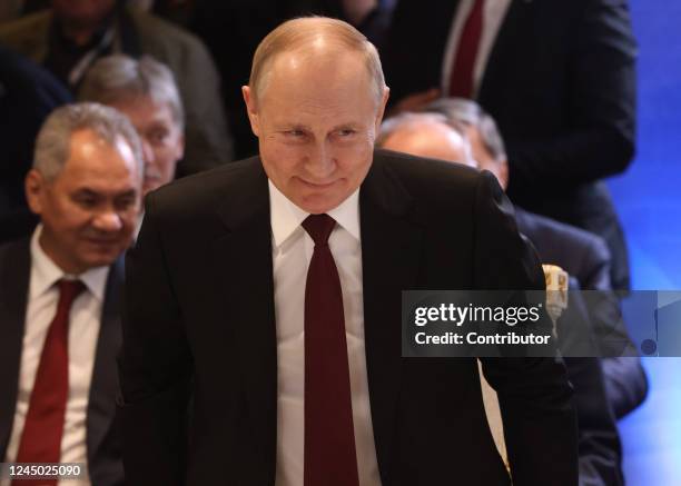 Russian President Vladimir Putin smiles as Defense Minister Sergei Shoigu looks on during the SCTO Summit, on November 23, 2022 in Yerevan, Armenia....