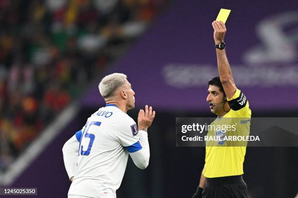 Emirati referee Abdulla Mohammed shoes the yellow card to Costa Rica's defender Francisco Calvo during the Qatar 2022 World Cup Group E football...