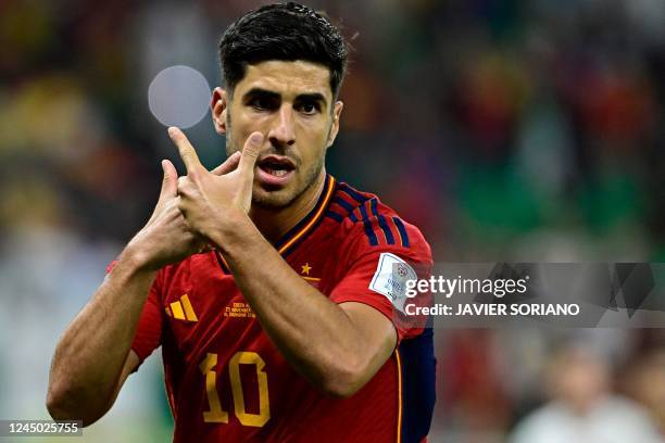 Spain's forward Marco Asensio reacts after scoring the second goal during the Qatar 2022 World Cup Group E football match between Spain and Costa...