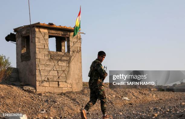 Kurdish Peshmerga fighter affiliated with Iran's separatist Kurdistan Freedom Party , mans a position near town city of Altun Kupri , north of...
