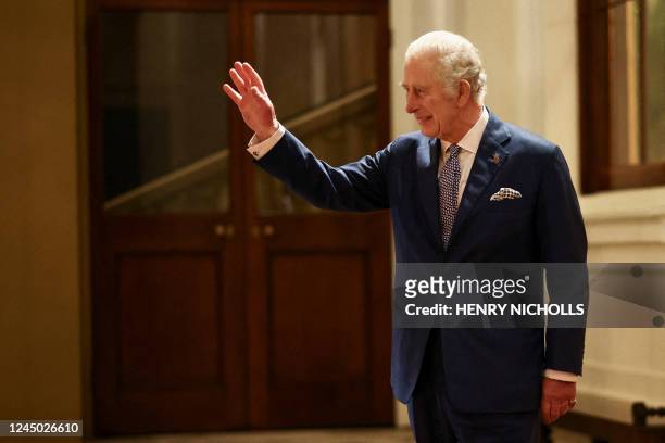 Britain's King Charles III waves as South Africa's President Cyril Ramaphosa is driven away following a formal farewell at Buckingham Palace in...