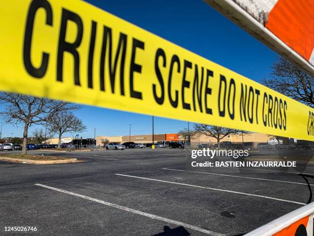 Crime scene tape blocks the parking lot outside of a Walmart following a mass shooting the night before in Chesapeake, Virginia on November 23, 2022....