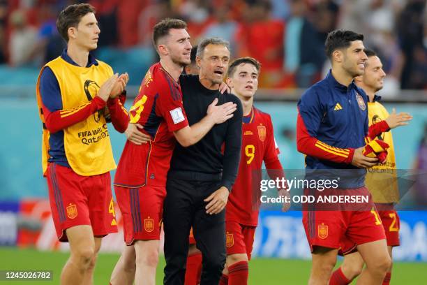 Spain's coach Luis Enrique congratulates his team on their victory after the Qatar 2022 World Cup Group E football match between Spain and Costa Rica...