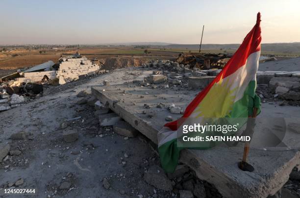 Kurdish flag is pictured amid the destruction caused by a reported Iranian rocket attack near town city of Altun Kupri , north of Kirkuk, in Iraq's...