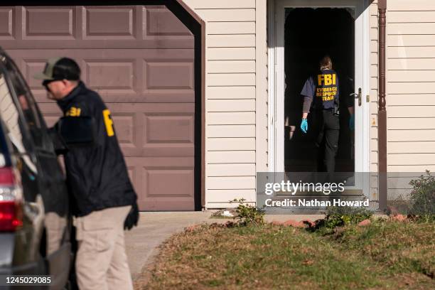 Members of the FBI search the home of the suspected gunman in the fatal shooting at a Walmart on November 23, 2022 in Chesapeake, Virginia. Six...